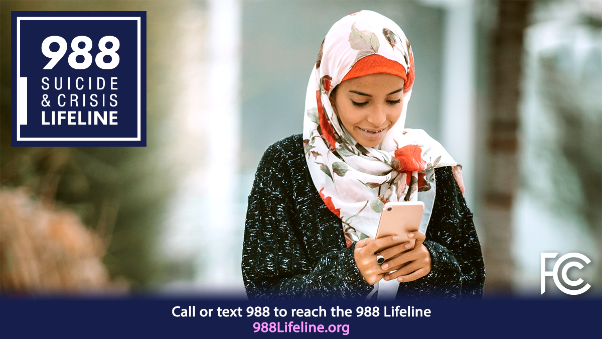 988 suicide and crisis lifeline, 988Lifeline.org - woman wearing headscarf texting on phone