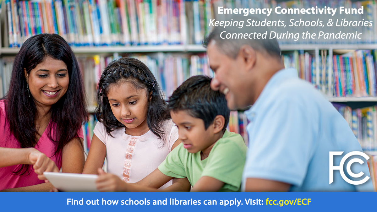 Emergency Connectivity Fund - family at table in library looking at a tablet computer