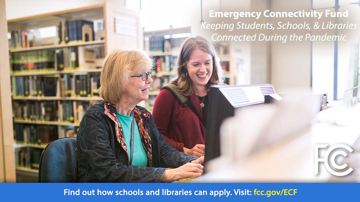 Emergency Connectivity Fund - senior woman and young woman at a library table looking at a computer